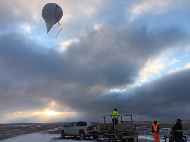 The tethered balloon crew bringing the balloon down after a successful day of flight.