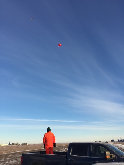 Al Bendure monitors the airspace as the DataHawk and tethered balloon do their work overhead.