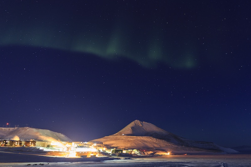 The lights of McMurdo Station under the Southern Lights (aurora australis). 