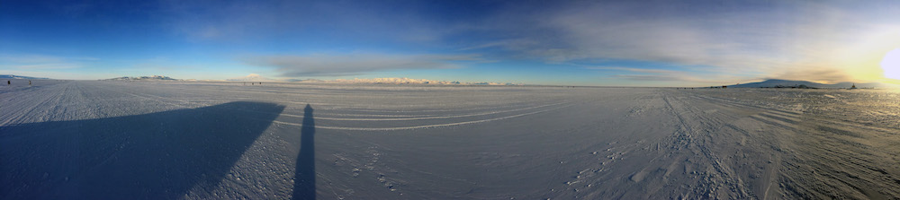 This is another view of sunrise from the Pegasus runway. Black Island is the leftmost high point on the horizon. To the right of Black Island is Mt. Discovery (the cone shaped snow covered peak), the Royal Society Range (center of the horizon), and Ross Island (left edge of photograph). 