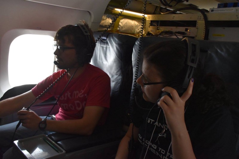 One of the SARP students learning about my instrument during the flight. Image courtesy of Jane Peterson.