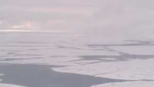 Broken ice over the Arctic Ocean north of Alaska and Canada.