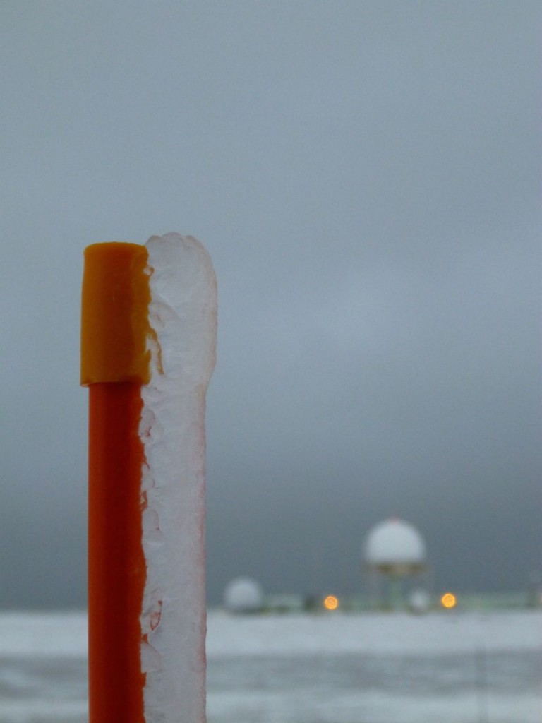 Ice accumulation on the orange sticks used to mark the edge of the gravel runway area and the stairs leading into the AMF3.