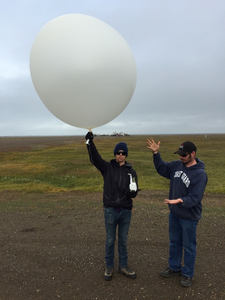 CU graduate student Nathan (left) and Oliktok operations technician Wessley (right) get ready to launch the 330 radiosonde from Oliktok Point!