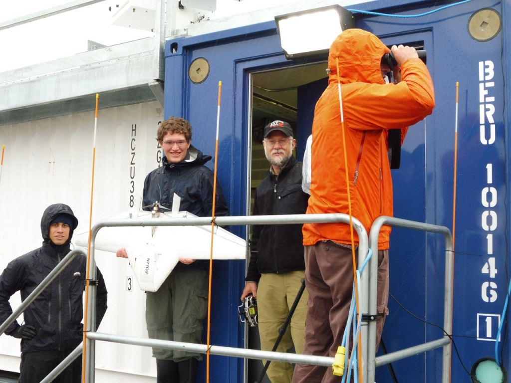 From left: Nathan, Will, Dale and Gijs, preparing for an aircraft radio range test.  Gijs is monitoring a grizzly bear that has been spotted far away from the site.
