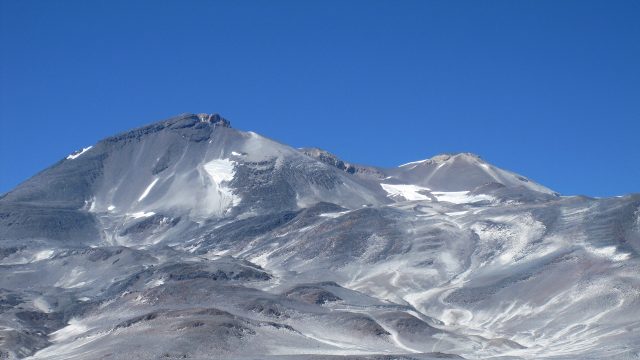 photo of the Ojos del Salado volcano against a blue sky